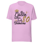 Lilac t-shirt with text 'This Queen makes look 80 fabulous' on a white background